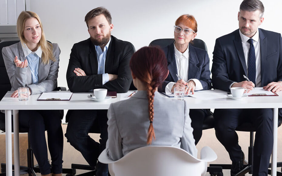 Student interviewing with group of people